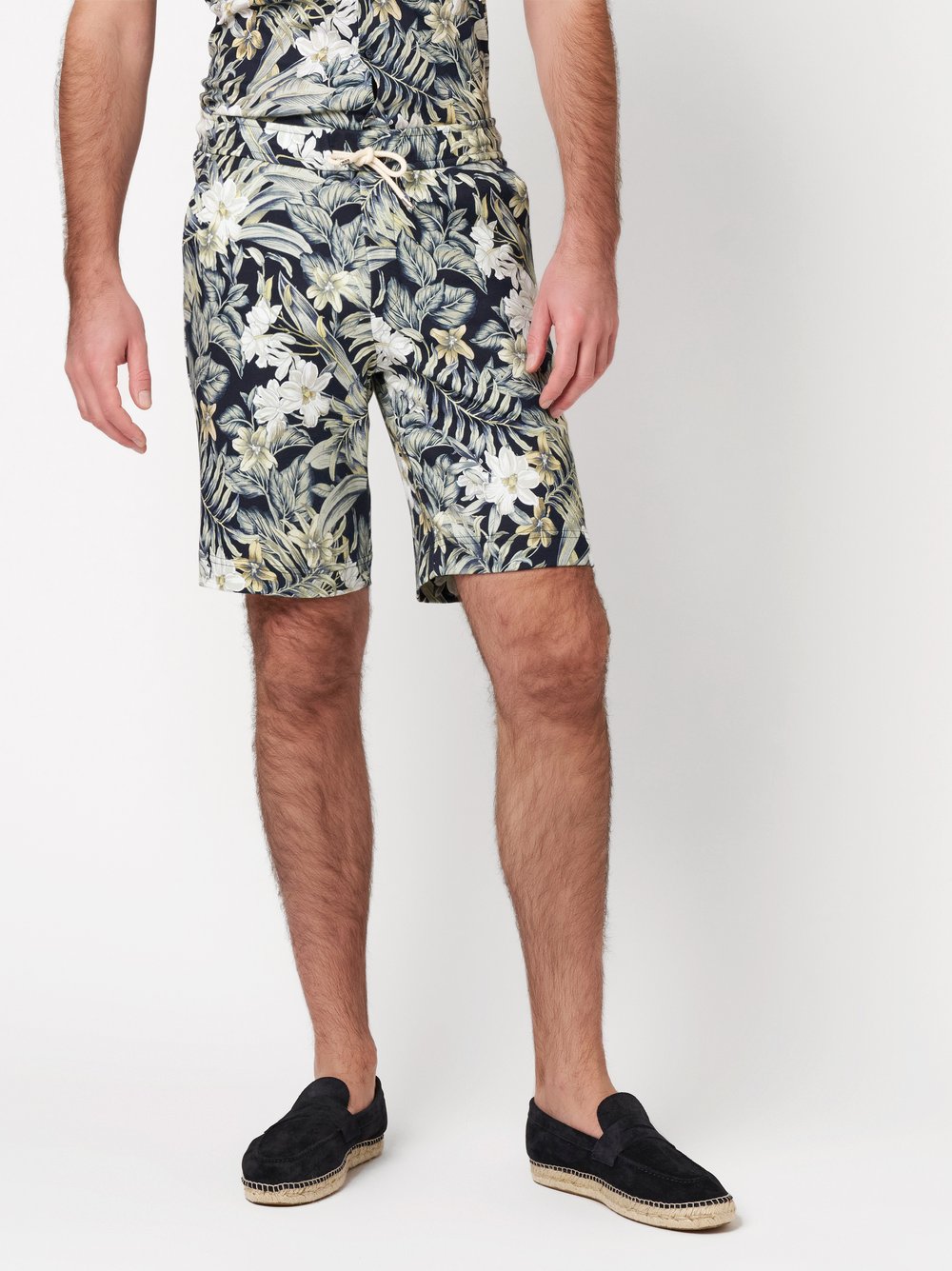 Mens shorts casual in pastel green flowers, front view worn by model