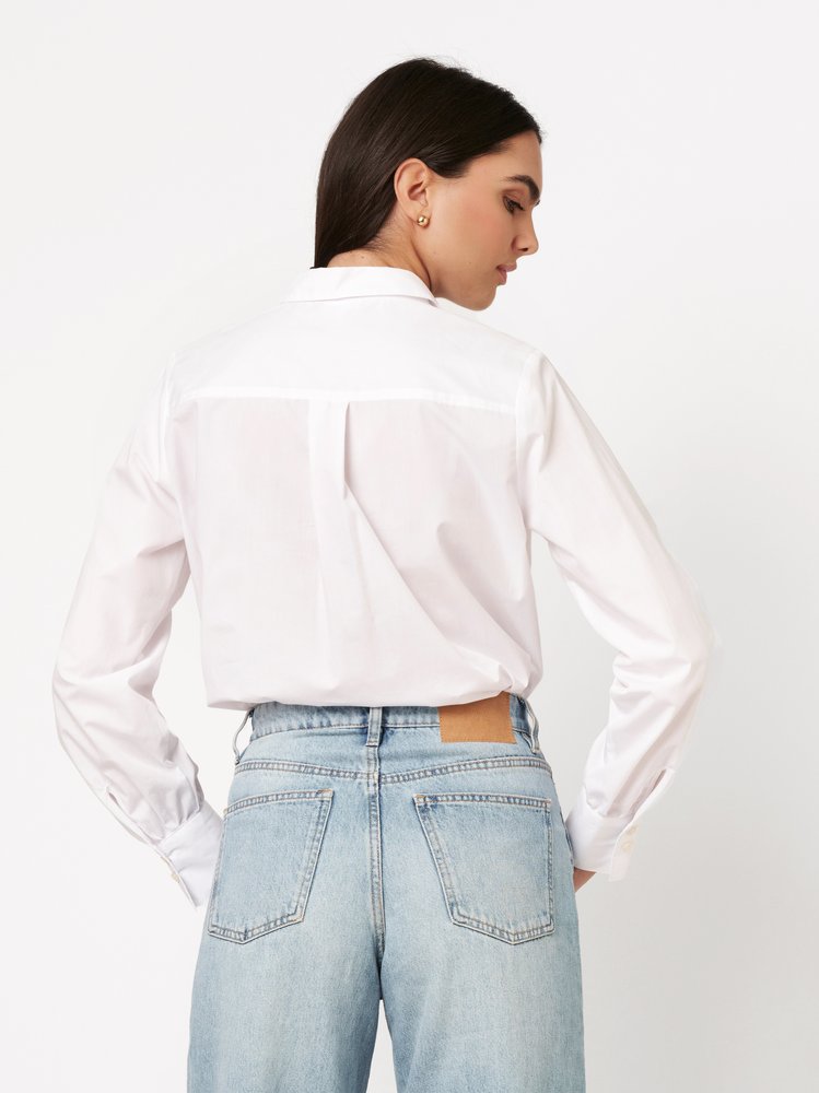 Womens blouse Lizzy in solid white, back view worn by model