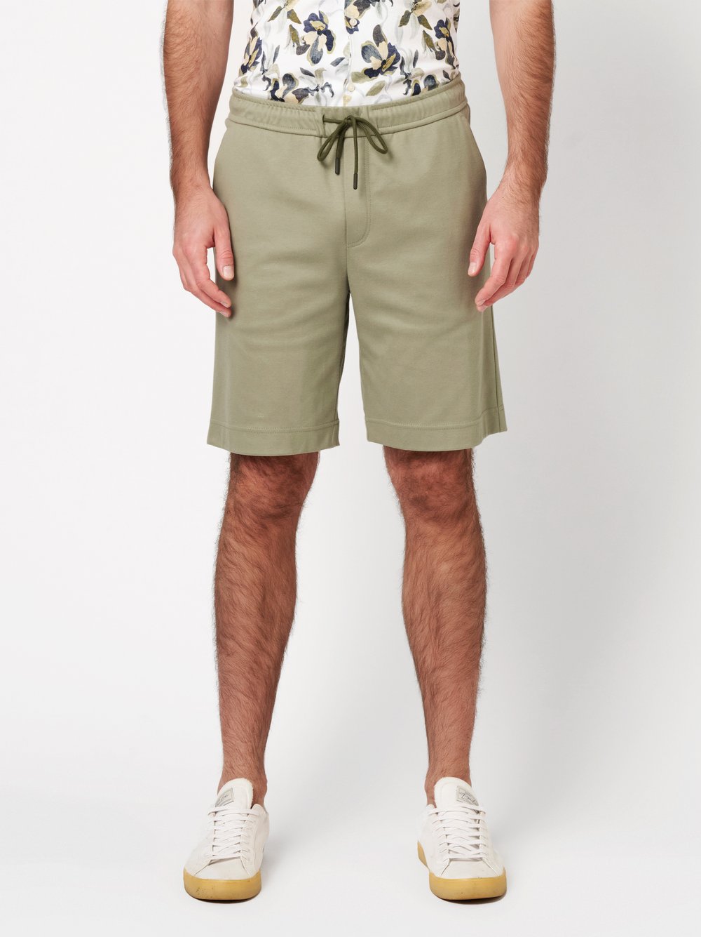 Mens shorts casual in solid green, front view worn by model