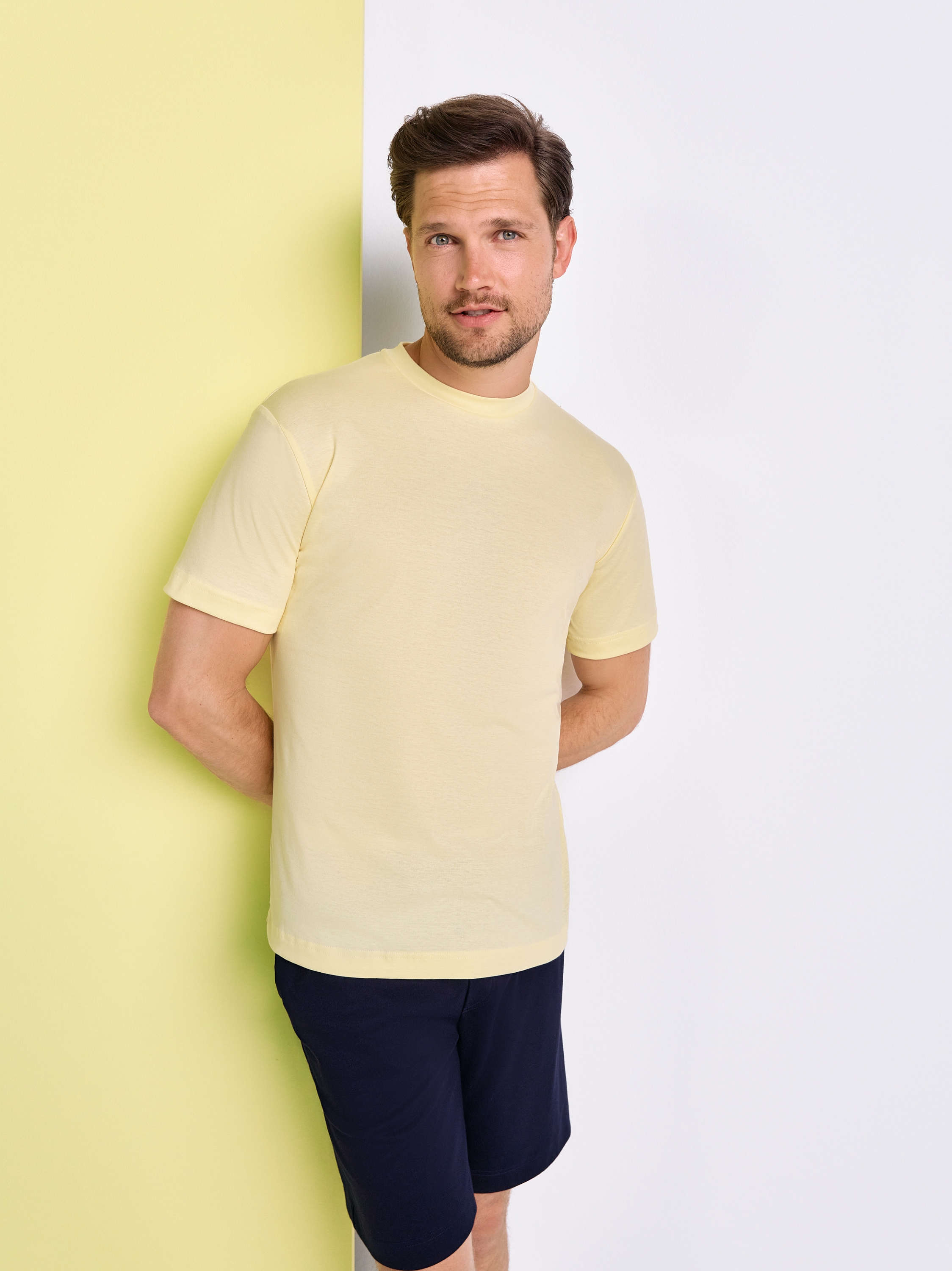 Mens T-shirt casual roundneck in solid yellow, front view worn by model