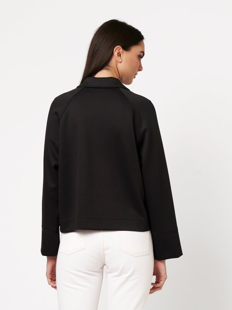 Womens blouse Sina in black, back view worn by model